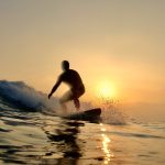 Alexis Piippo surfing sunset