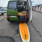 Alexis Piippo buss mossa with surfboard